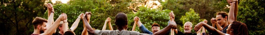 Group of people holding hand together in the park